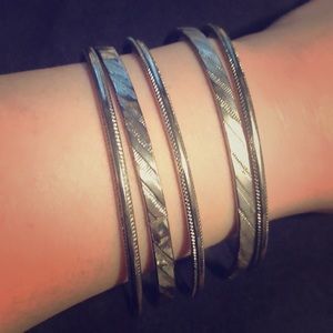 5 Silver metal bangle bracelets w/ design